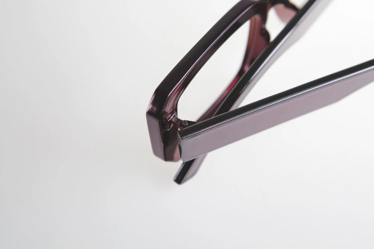 Close-up of a finished burgundy eyewear frame and temple
